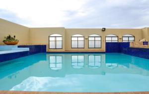 a large pool with blue water in a building at 802 The Bermudas - by Stay in Umhlanga in Durban