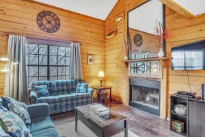 a living room with a couch and a fireplace at 3 Bedroom Log Cabin Condo close to Everything! in Branson