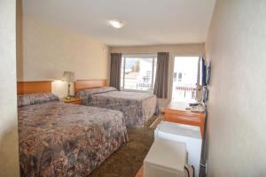 Postel nebo postele na pokoji v ubytování Shoreline Resort Condominiums