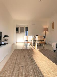 a white living room with a table and a couch at Sea Avenue House - center Baleal - walk to surf in Ferrel