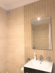 a bathroom with a sink and a mirror at Sea Avenue House - center Baleal - walk to surf in Ferrel +45 photos