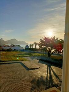 a view of the sunset from a patio with a tree at Golden Beach House in Porto Santo