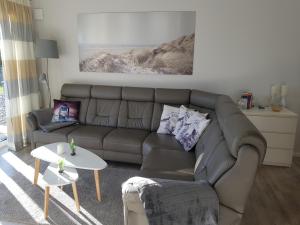 a living room with a couch and a table at Ferienwohnung MeerZeit EG in Altefähr