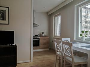 a kitchen with a table and chairs and a dining room at Pyynikin Rauha in Tampere