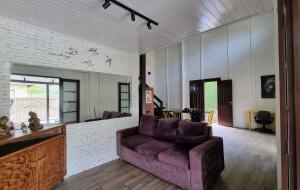 a living room with a couch and a table at Casa do Beija-Flor in Florianópolis +41 photos