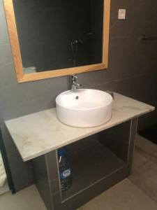 a bathroom counter with a sink and a mirror at Apartamento t1 mobiliado com Wi-Fi in Praia