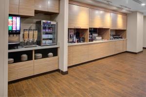 a kitchen with wooden cabinets and aasteryasteryasteryasteryasteryasteryasteryasteryastery at TownePlace Suites by Marriott Albany in Albany