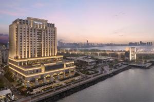 a view of a large building with a river at The Westin Haikou in Haikou