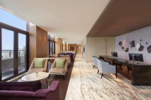 a living room with couches and a desk and a table at The Westin Haikou in Haikou