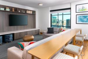 a living room with a large couch and a tv at Element Atlanta Midtown in Atlanta