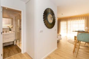 a living room with a large clock on the wall at Marinha Grande apartamentos N5 ICE in Marinha Grande