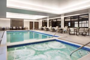 a hotel pool with chairs and tables and chairs at Residence Inn by Marriott Boulder Canyon Boulevard in Boulder