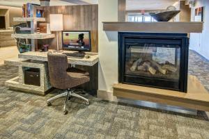 a office with a computer and a desk with a fireplace at Residence Inn by Marriott Blacksburg-University in Blacksburg