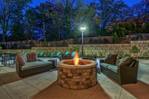a fire pit in a patio with couches and chairs at Residence Inn by Marriott Blacksburg-University in Blacksburg