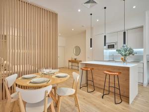 a kitchen and dining room with a wooden table and chairs at Paseo Suites Hotel in Madrid