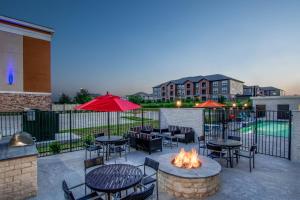 a patio with tables and chairs and a fire pit at TownePlace Suites by Marriott Waco South in Waco