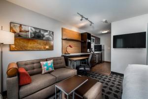 a living room with a couch and a table at TownePlace Suites by Marriott Waco South in Waco