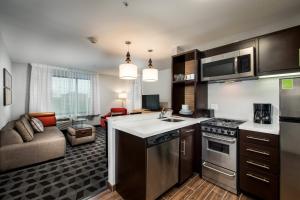 a kitchen and living room with a couch in a room at TownePlace Suites by Marriott Waco South in Waco