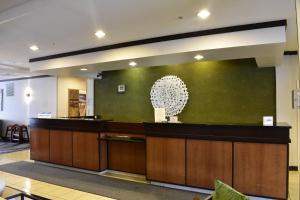 a lobby with a reception desk and a green wall at Fairfield Inn and Suites by Marriott Strasburg Shenandoah Valley in Strasburg