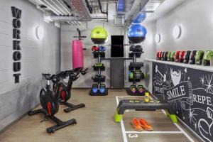 un gimnasio con un montón de equipos de ejercicios. en Moxy Lausanne City, en Lausana