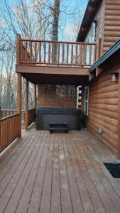 a large deck with a bench on a house at Flying High Luxury Cabin in Campbellsville +9 photos