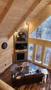 a living room with a couch and a fireplace in a cabin at Flying High Luxury Cabin in Campbellsville