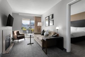 a hotel room with a couch and a bed at Residence Inn by Marriott Salt Lake City Downtown in Salt Lake City