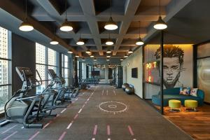 a gym with treadmills and cardio equipment in a building at Aloft Shijiazhuang in Shijiazhuang