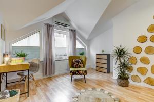 a living room with a desk and a chair at Apartament Abra 2 Rynek 8 in Muszyna