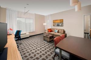 a living room with a couch and a table at TownePlace Suites by Marriott Alexandria Fort Belvoir in Woodlawn