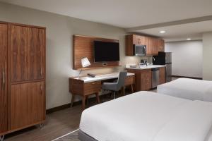 a hotel room with a bed and a desk with a computer at Four Points by Sheraton Vaughan in Vaughan