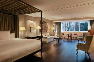 a bedroom with a bed and a living room at Hôtel de Berri Champs-Élysées, a Luxury Collection Hotel in Paris