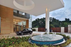 a car parked in front of a building with a fountain at Four Points by Sheraton Kochi Infopark in Cochin