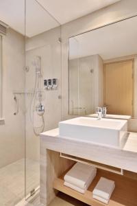 a bathroom with a sink and a shower at Four Points by Sheraton Kochi Infopark in Cochin