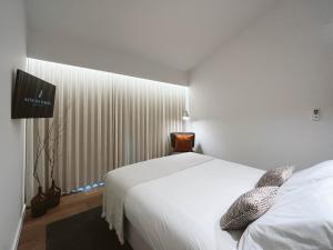 Uma cama ou camas num quarto em Alto do Ferrum - Boutique Villa