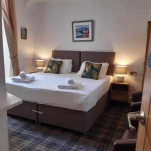 Ένα ή περισσότερα κρεβάτια σε δωμάτιο στο The Merrydale Guest House