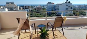 balcone con 2 sedie e vista sulla città di Perfect View Luxury Apartment a Ierápetra
