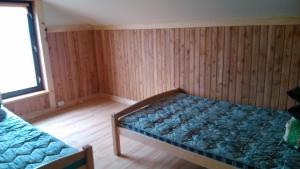 a bedroom with a bed in a room with wooden walls at Udu Holiday House in Änkküla