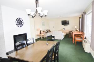 a living room with a table and a dining room at Shoreline Resort Condominiums in Penticton