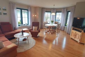 a living room with a couch and a table at Ferienwohnung Weiherblick, Vulkaneifel in Mosbruch