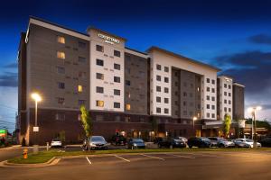 a hotel building with cars parked in a parking lot at Courtyard by Marriott Charlotte Northlake in Charlotte