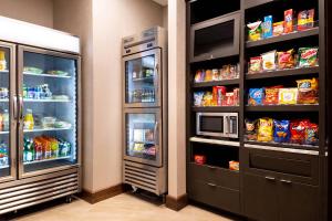 a kitchen with an open refrigerator with food inside at Courtyard by Marriott Charlotte Northlake in Charlotte