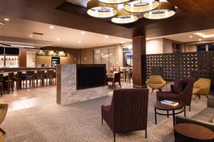 a hotel lobby with a bar and a restaurant at Courtyard by Marriott Charlotte Northlake in Charlotte