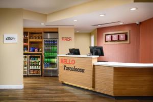 a lobby of a hotel with a helloethos counter at TownePlace Suites by Marriott Tuscaloosa in Tuscaloosa