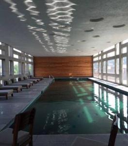 a swimming pool in a building with windows at Super cool & comfortable in the heart of Condesa. in Mexico City