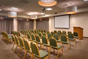 a conference room with chairs and a screen at SpringHill Suites by Marriott Rexburg in Rexburg