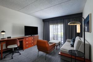 a living room with a couch and a tv at Courtyard by Marriott San Antonio Downtown in San Antonio