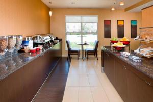 a kitchen with a counter with a table and chairs at Residence Inn by Marriott Amarillo in Amarillo