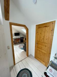 a room with a wooden door and a living room at Zentrale Idylle in Kempten in Kempten