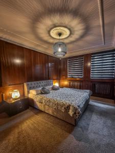 a bedroom with a large bed with a ceiling at GARDENIA in Jelenia Góra